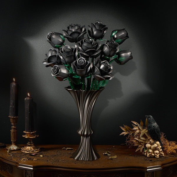 Black rose bouquet in a metal vase with candles, a raven and skulls on an antique table