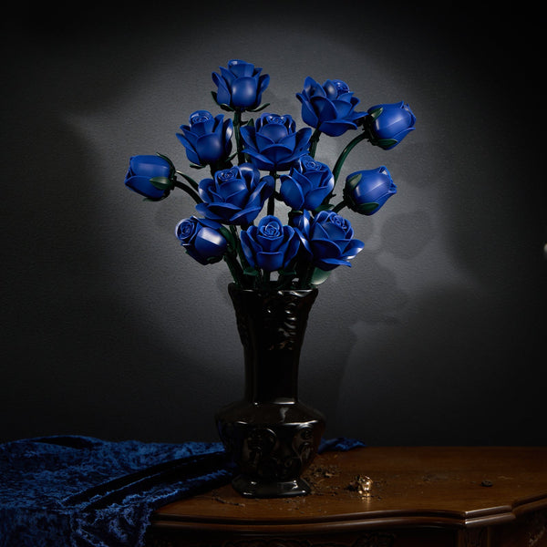 Blue rose bouquet in a carved dark vase with blue velvet drapery