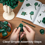 Hands assembling a green rose beside the open guide and the loose pieces
