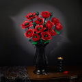 Red poppy bouquet in a black vase on an antique table against a dark background