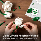 Hands clicking a white rose petal into place beside the loose pieces and the illustrated guide