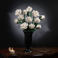 White rose bouquet in a carved black vase on an antique table against a dark background