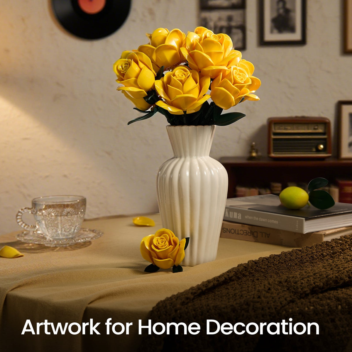 Yellow roses in a white vase on a table beside a vintage radio