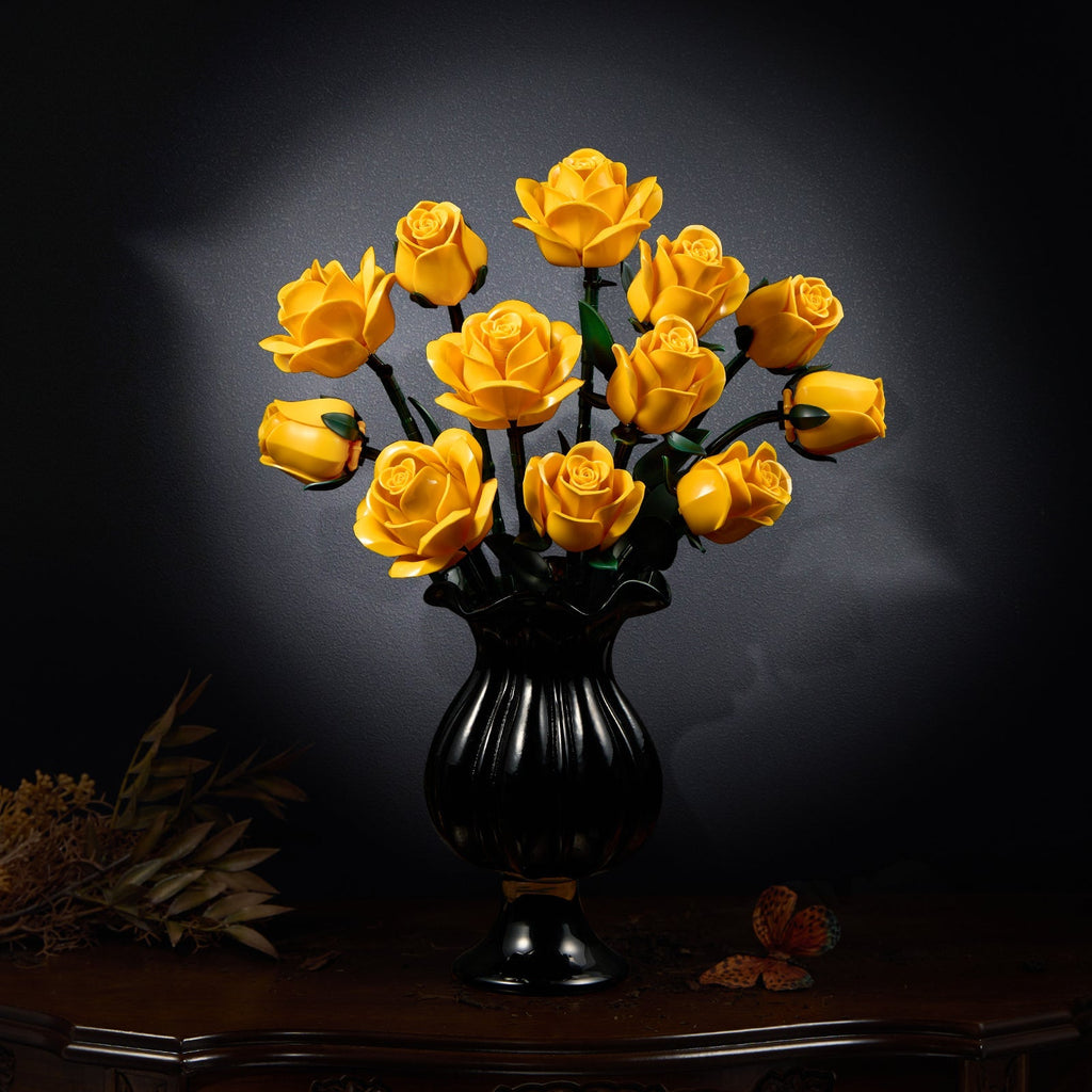 Yellow rose bouquet in a black vase on a dark table
