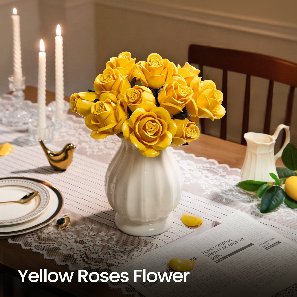 Yellow roses in a white vase on a laid dining table with lit candles